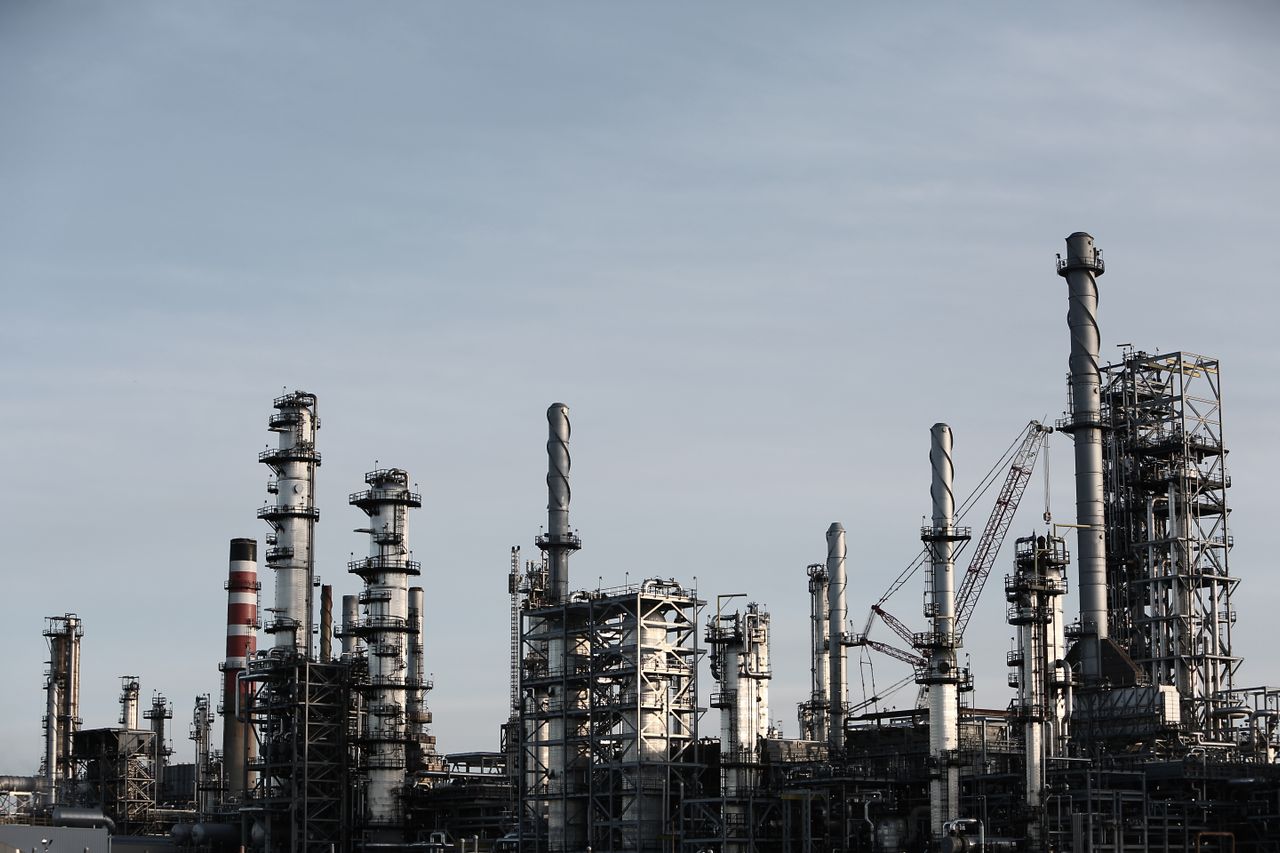 Refinery towers silhouetted at dusk