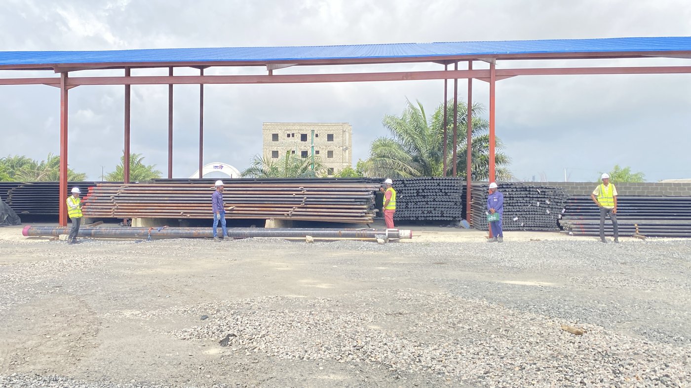 Steel casing and tubing stacked under a storage shelter at a BRADE OCTG yard in Nigeria