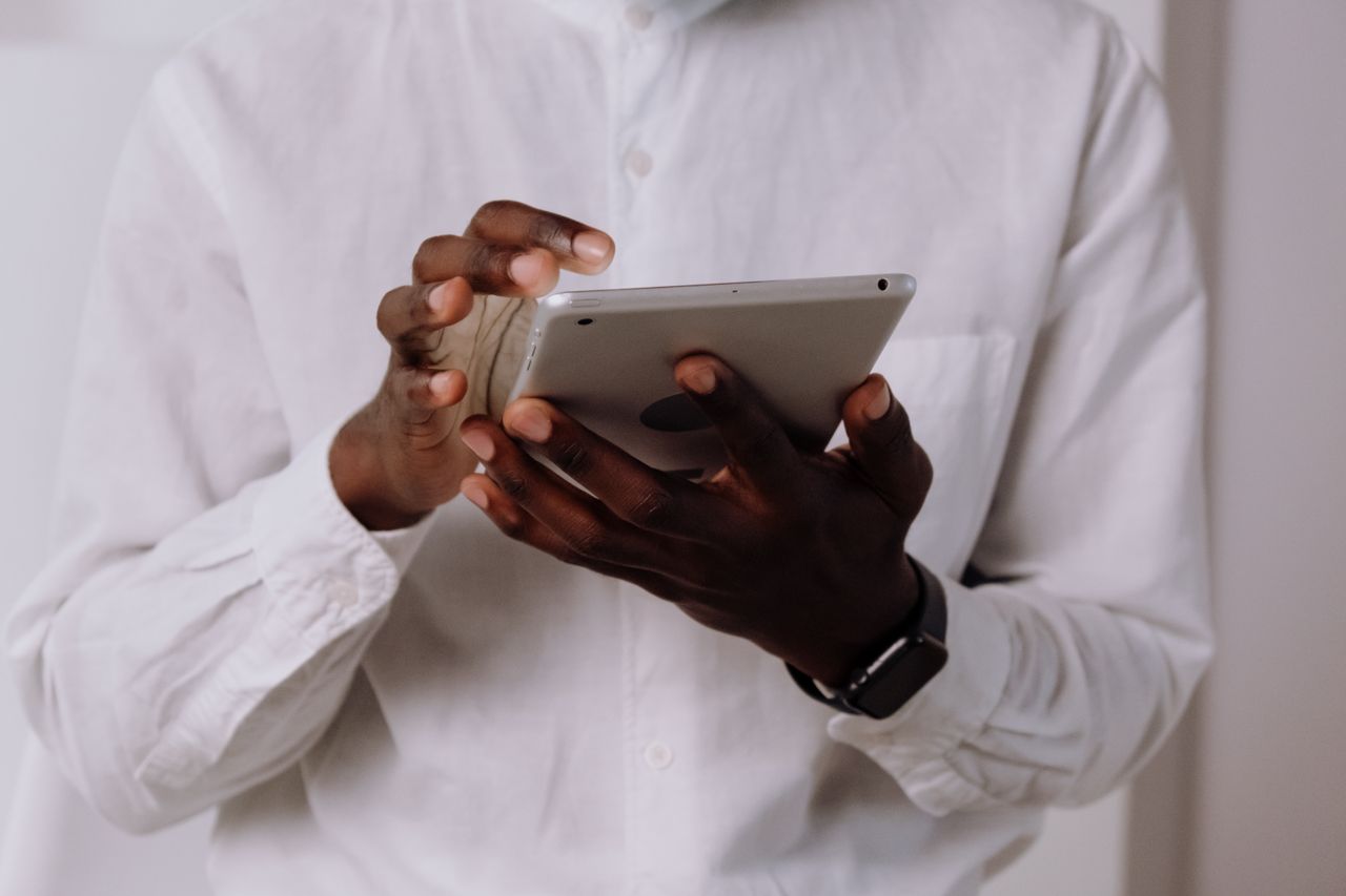Close-up of hands using a tablet device